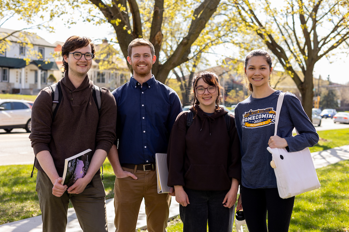 Three CSP students walking together outside on campus.