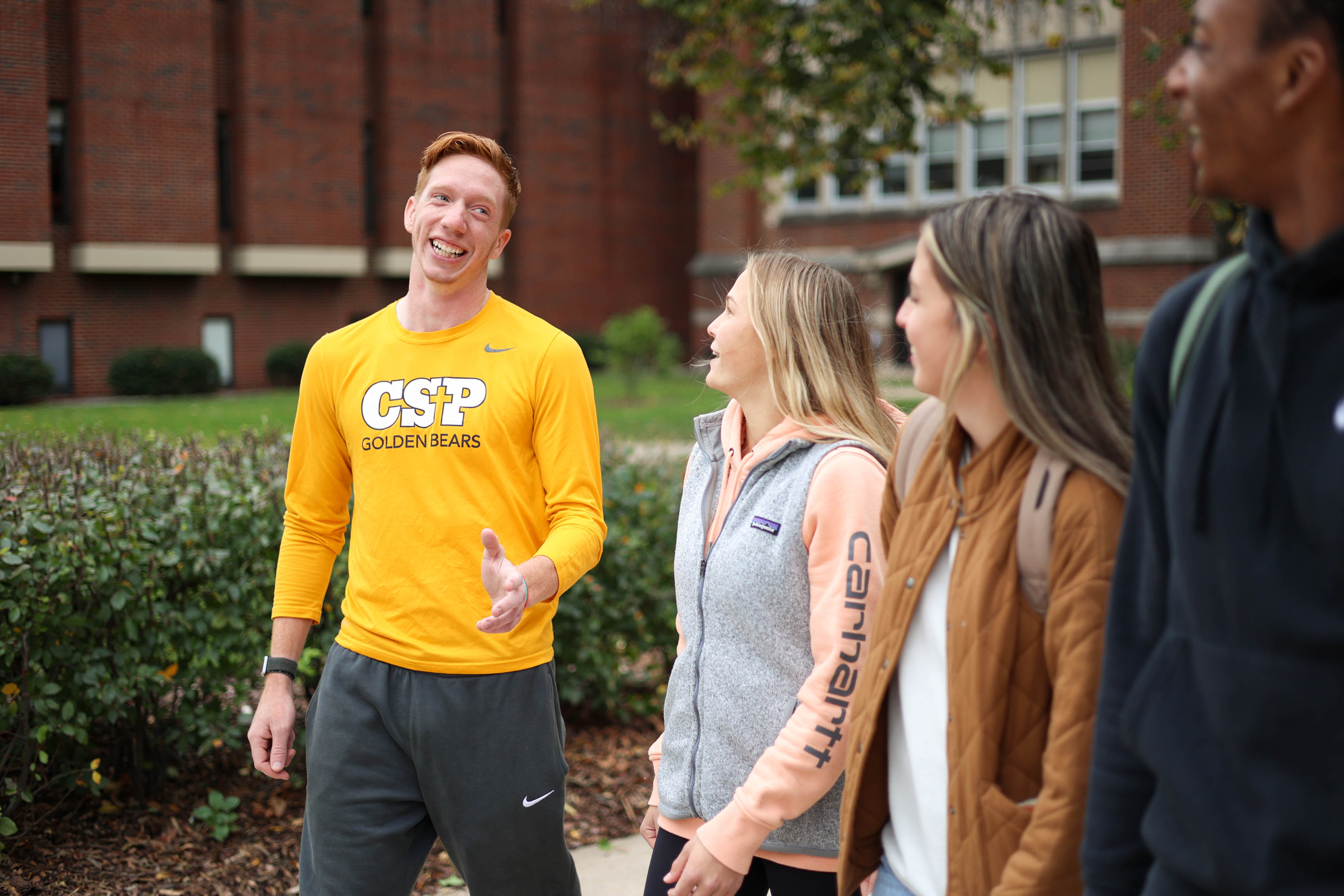 Four students walking on the CSP campus.